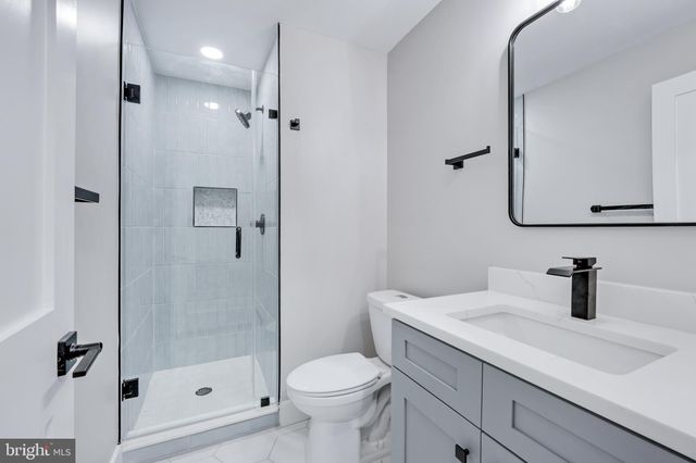 a bathroom with a glass shower door