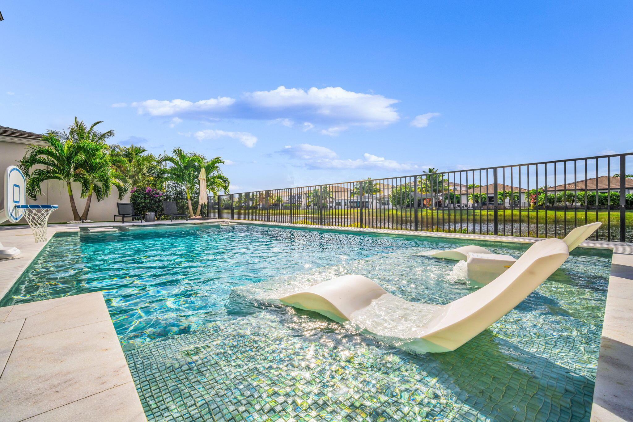 17059 Rainbow Fls Trail Boca Raton, FL 33496 - Photo 52 of 79 a view of a swimming pool with a patio