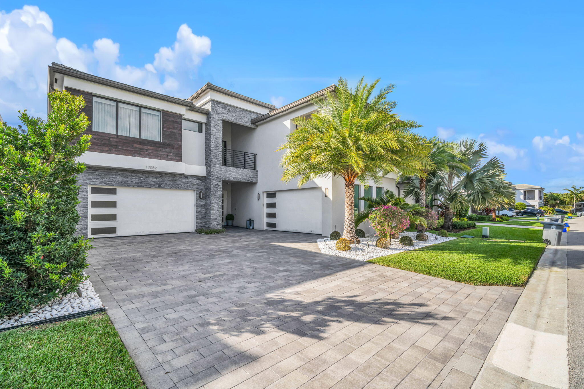 17059 Rainbow Fls Trail Boca Raton, FL 33496 - Photo 70 of 79 a front view of a house with a yard and a garage