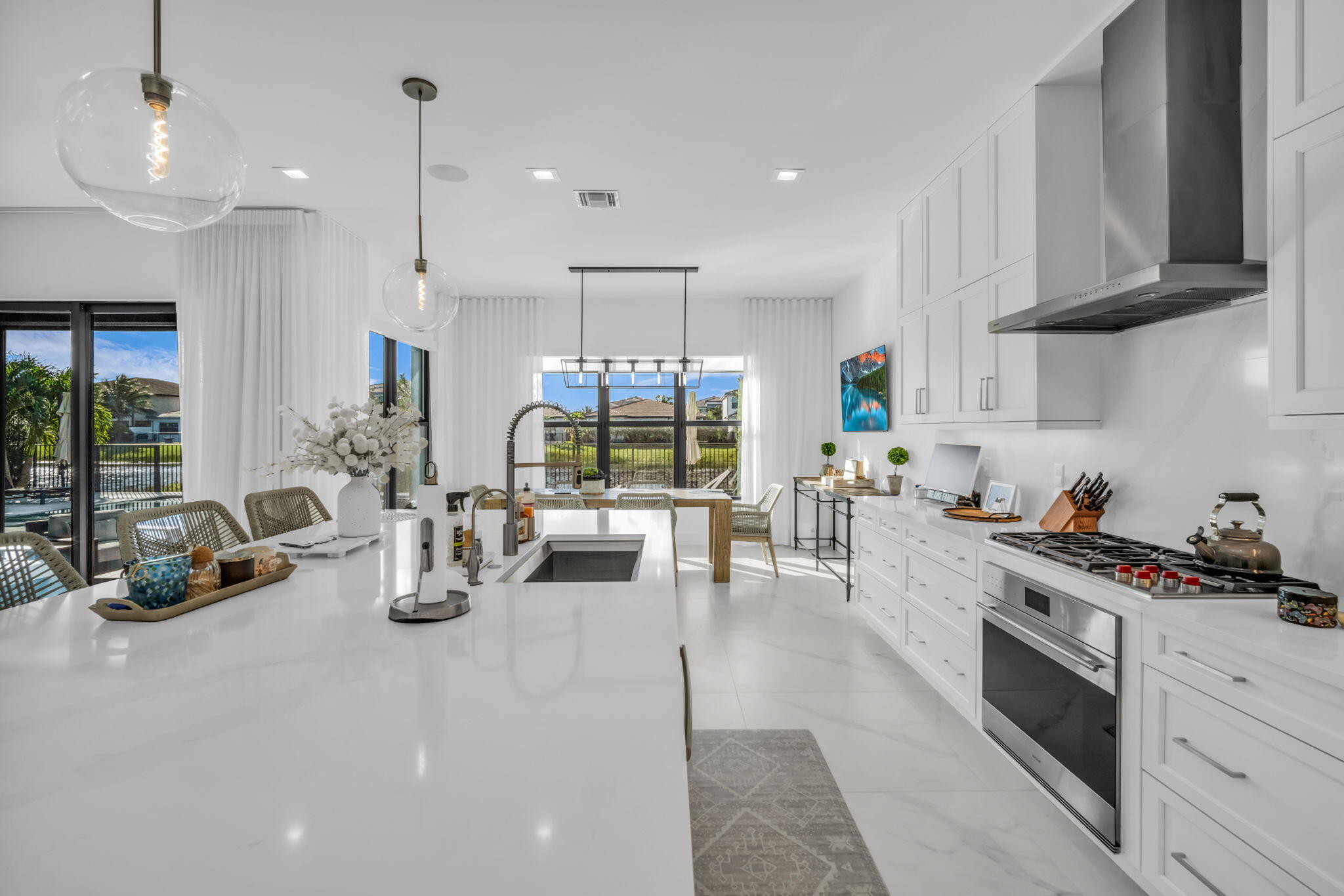 17059 Rainbow Fls Trail Boca Raton, FL 33496 - Photo 9 of 79 a kitchen with stainless steel appliances granite countertop a stove and a view of living room with windows