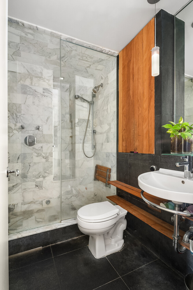 2166 Broadway, Unit 11B Manhattan, NY 10024 - Photo 13 of 14 a bathroom with a sink a toilet and shower