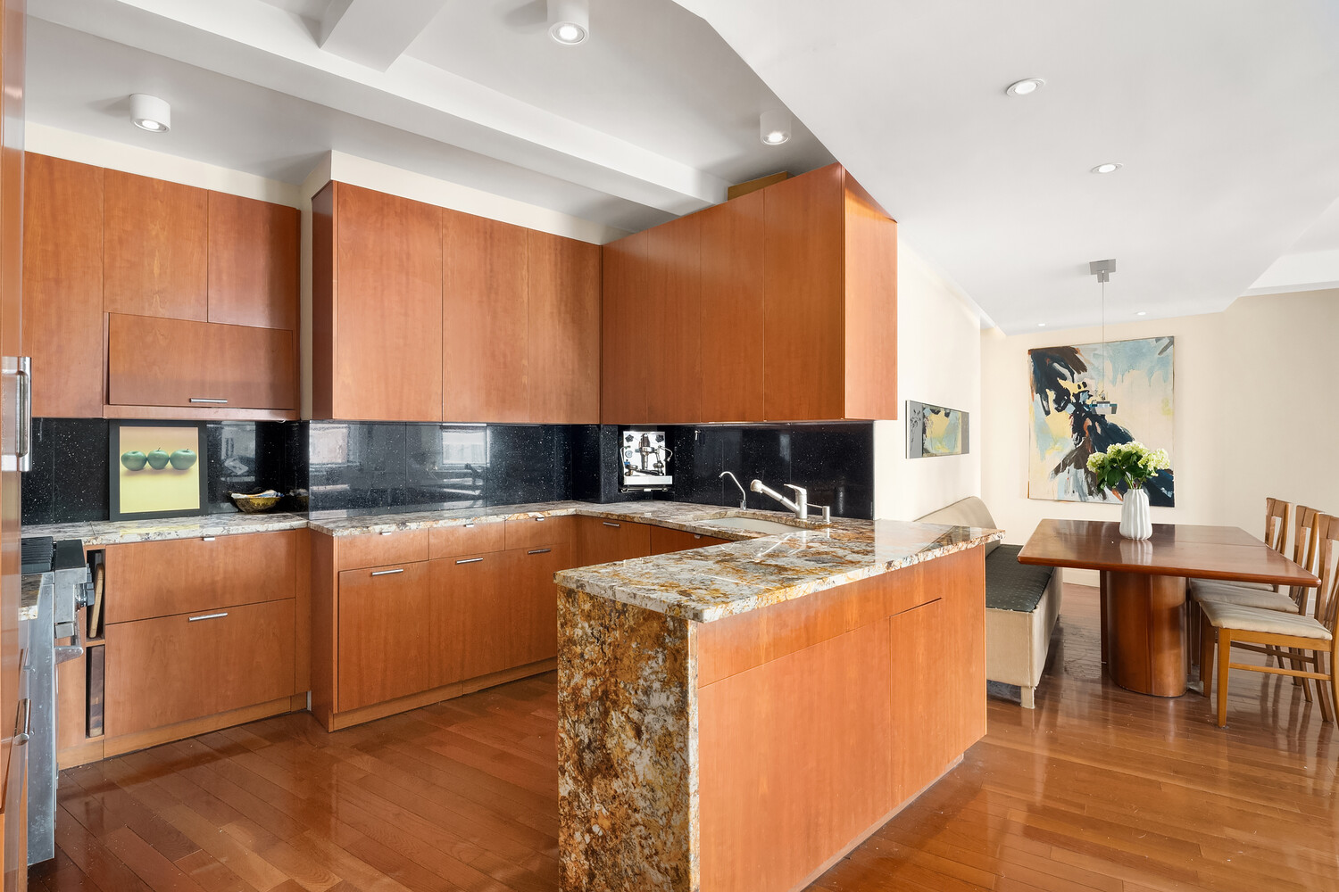 2166 Broadway, Unit 11B Manhattan, NY 10024 - Photo 5 of 14 a kitchen with stainless steel appliances granite countertop a refrigerator a stove and a sink with wooden floor