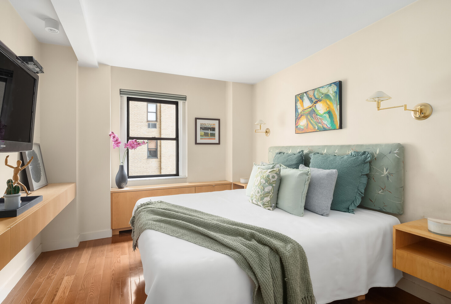 2166 Broadway, Unit 11B Manhattan, NY 10024 - Photo 9 of 14 a bedroom with a bed and a flat screen tv