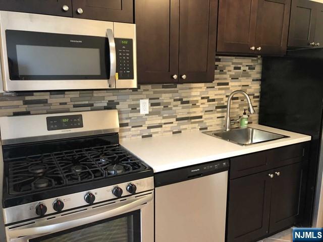 2205 North Central Road, Unit 5A Fort Lee, NJ 07024 - Photo 12 of 24 a kitchen with kitchen island a sink stove and microwave