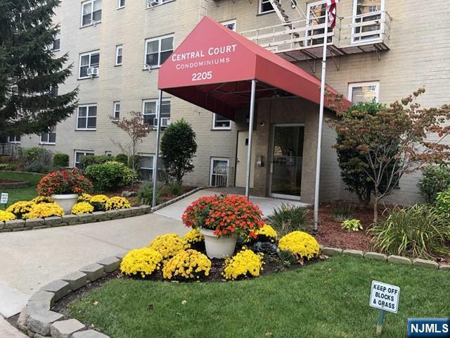 2205 North Central Road, Unit 5A Fort Lee, NJ 07024 - Photo 2 of 24 a front view of a house with a garden and outdoor seating