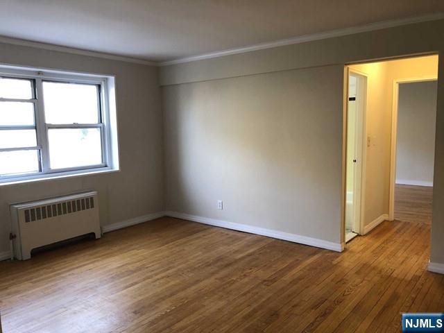 2205 North Central Road, Unit 5A Fort Lee, NJ 07024 - Photo 6 of 24 an empty room with wooden floor and windows