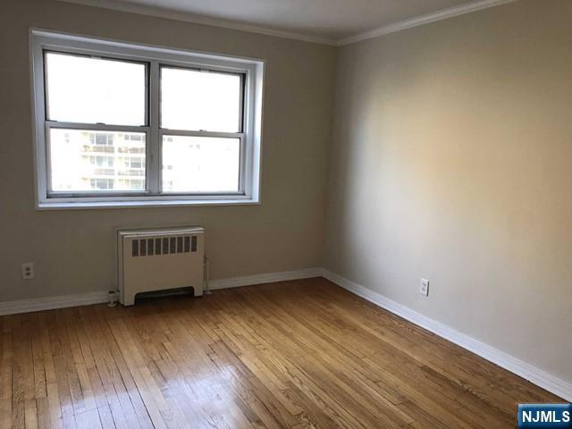 2205 North Central Road, Unit 5A Fort Lee, NJ 07024 - Photo 10 of 24 an empty room with wooden floor and windows