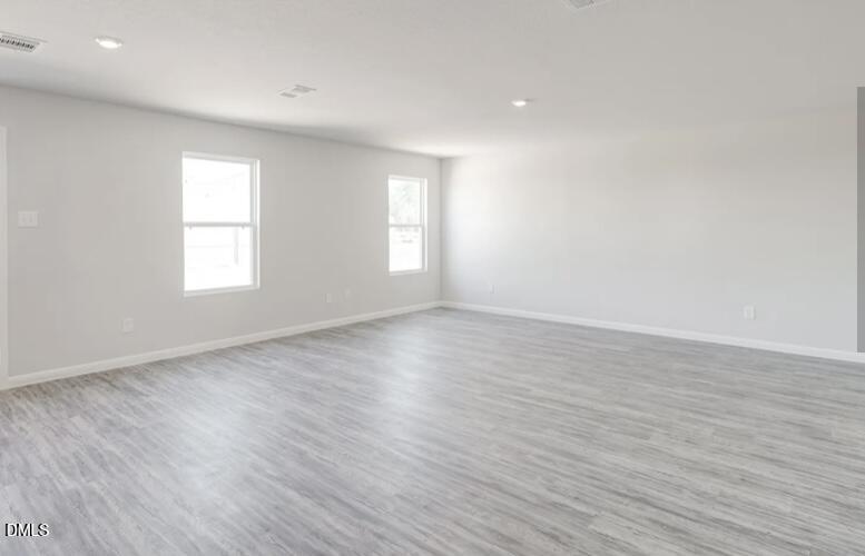 73 Lillian Court Roxboro, NC 27573 - Photo 4 of 8 an empty room with wooden floor and windows