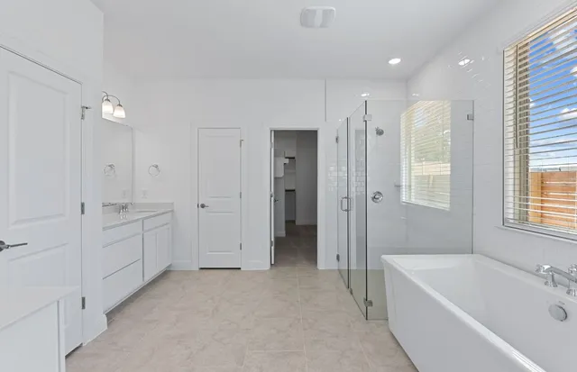 an empty room with wooden floor and ceiling fan
