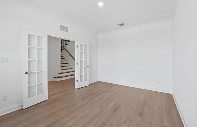 a view of wooden floor and windows in a room