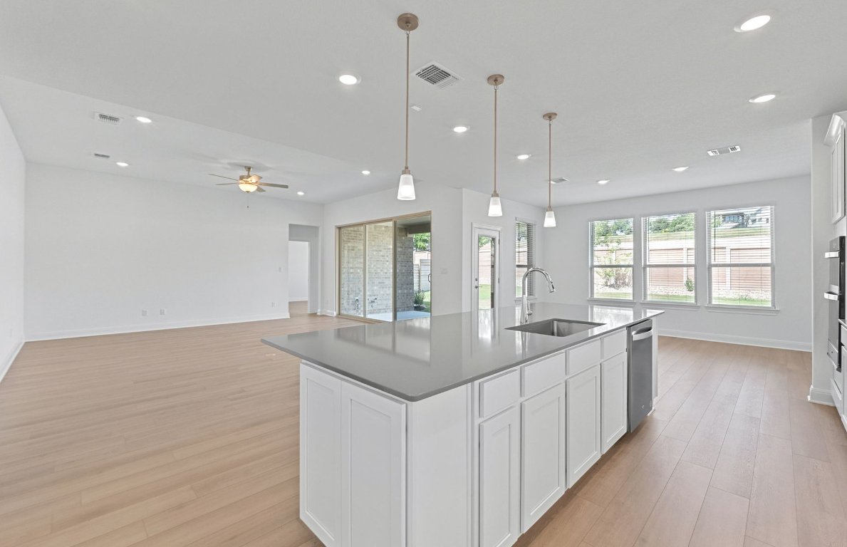 3109 Delaware Street Leander, TX 78641 - Photo 4 of 21 a kitchen with stainless steel appliances granite countertop a sink a counter space and a window