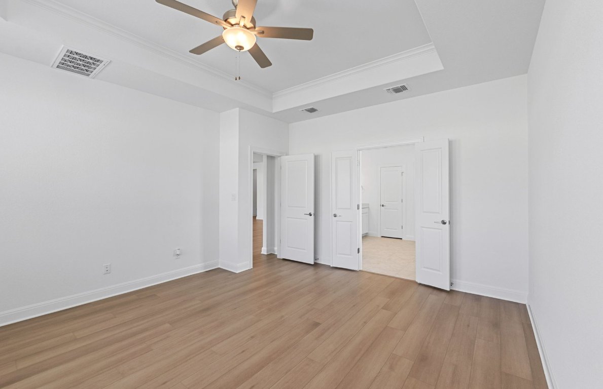 3109 Delaware Street Leander, TX 78641 - Photo 8 of 21 an empty room with wooden floor and ceiling fan