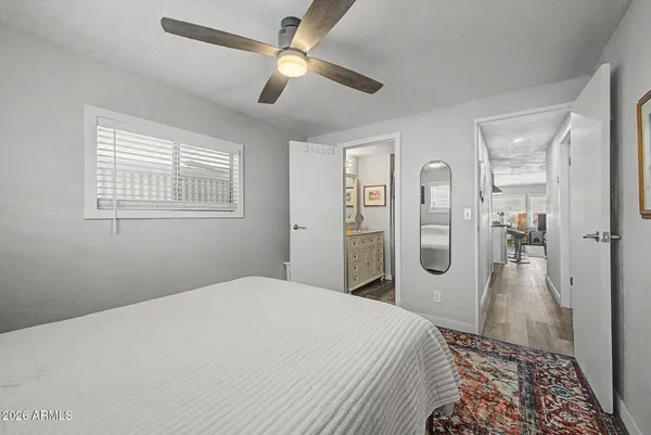 a bedroom with a large bed and a chandelier