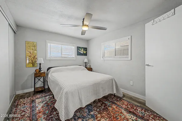 a bedroom with a bed and wooden floor