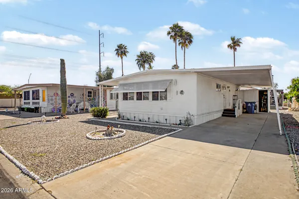 a front view of a house with basket ball court and palm tree
