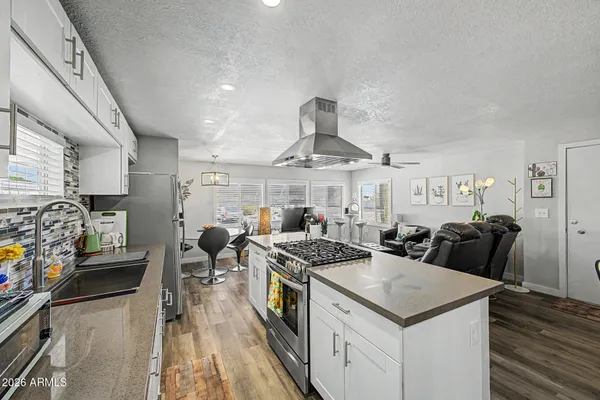 a kitchen with stainless steel appliances granite countertop a stove and a refrigerator