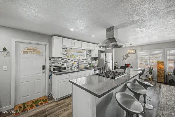 a kitchen with stainless steel appliances granite countertop a sink and cabinets