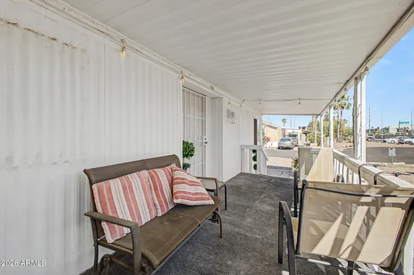 a living room with furniture a rug and a painting on the wall
