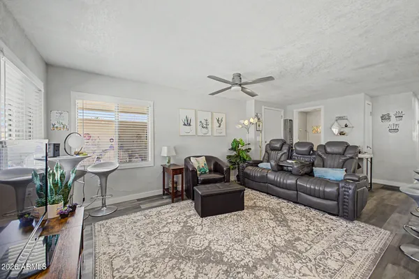 a living room with furniture and wooden floor