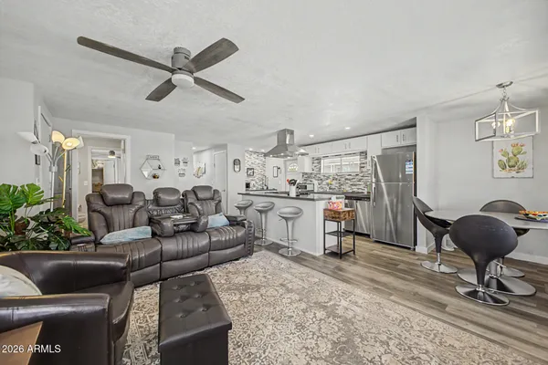 a living room with furniture and a chandelier