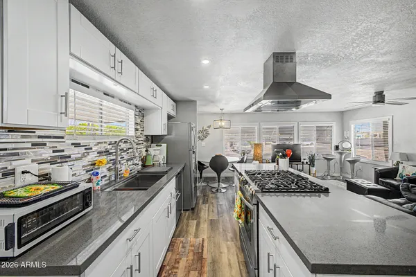a kitchen with stove and cabinets
