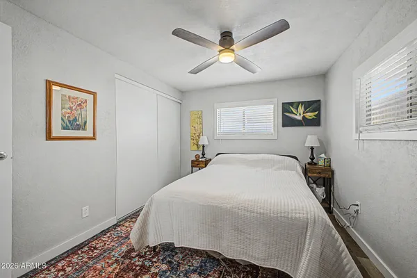 a bedroom with a large bed and a chandelier