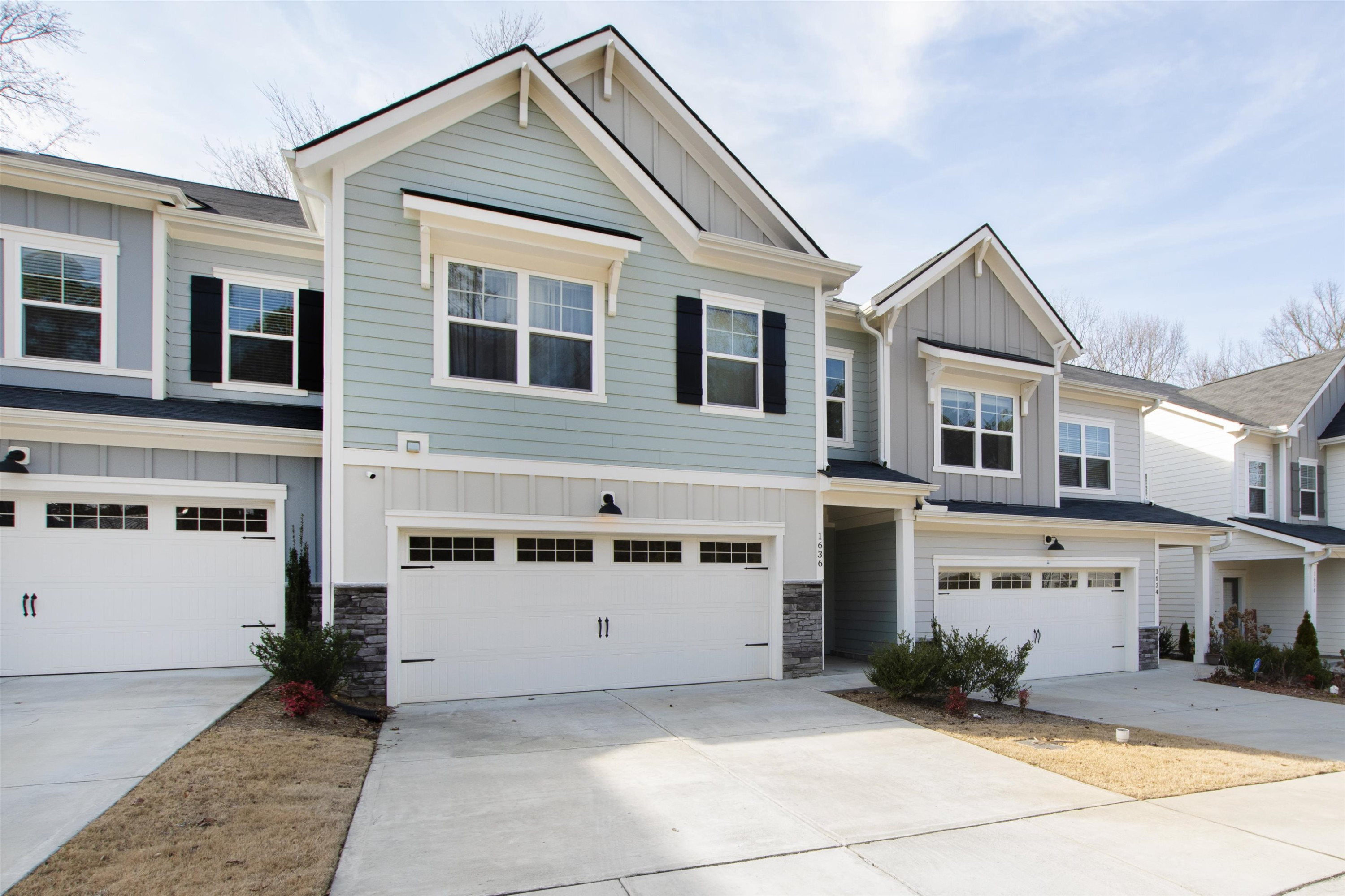 a view of a white house with windows and refrigerator