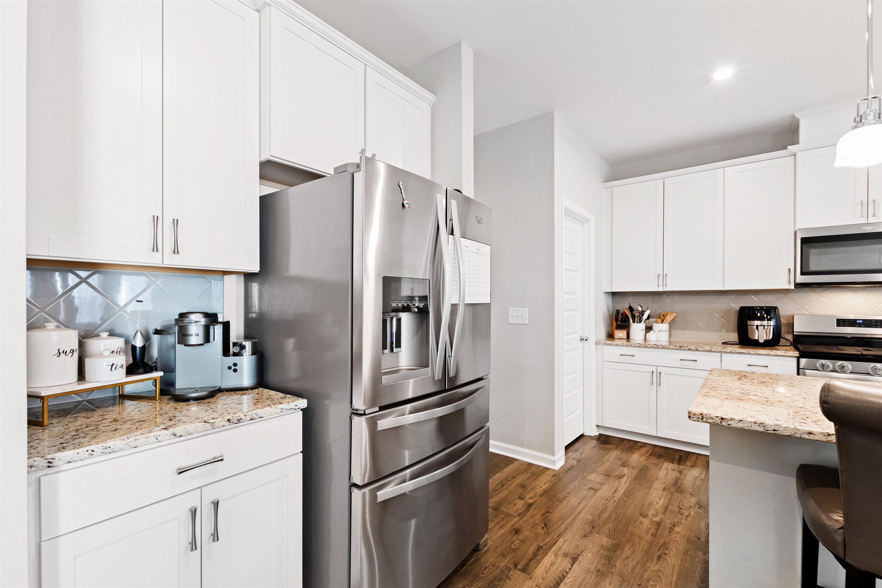1636 Brussels Drive Apex, NC 27502 - Photo 12 of 35 a kitchen with stainless steel appliances white cabinets and a refrigerator