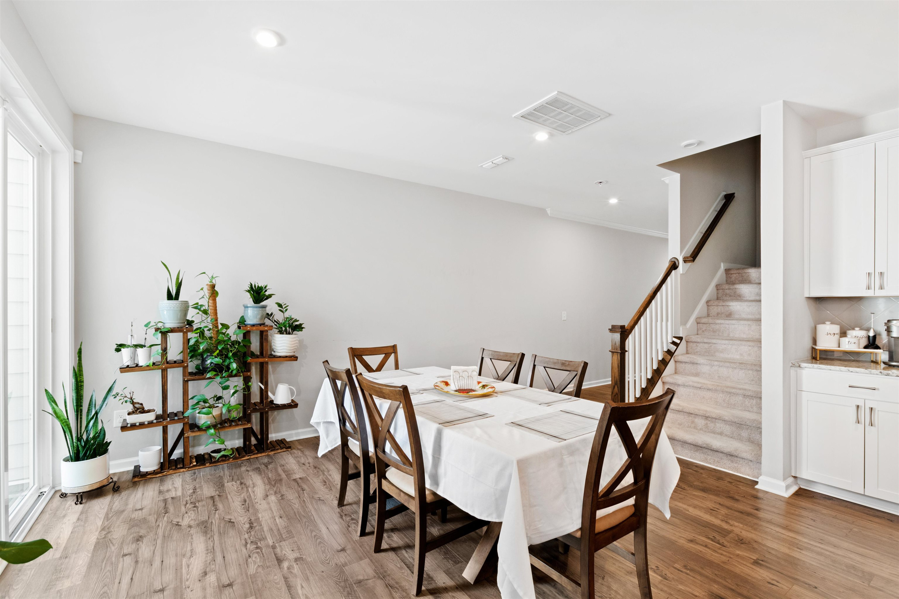 1636 Brussels Drive Apex, NC 27502 - Photo 6 of 35 a view of a dining room with furniture and wooden floor