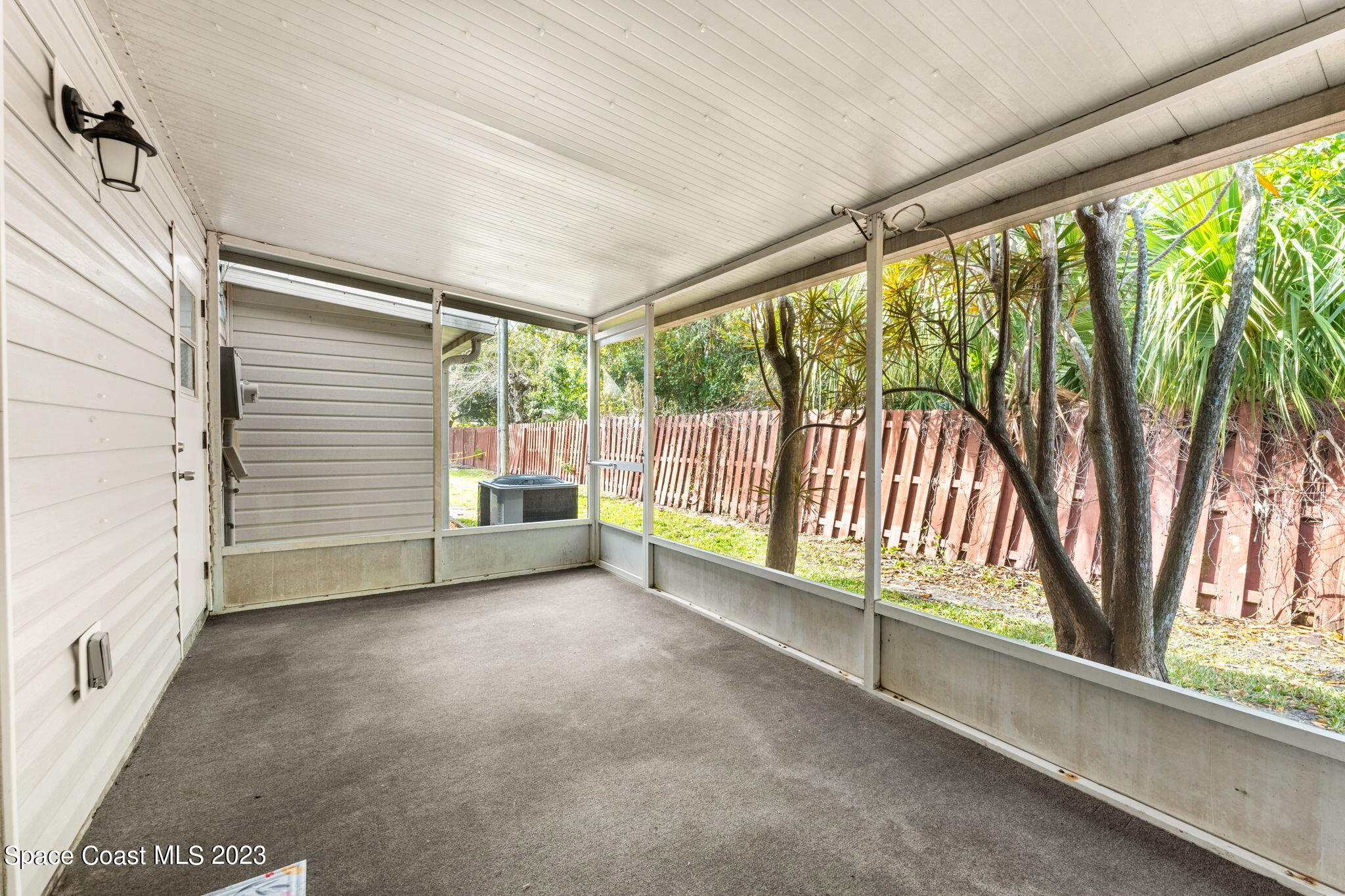 2717 Manor Drive Northeast Palm Bay, FL 32905 - Photo 12 of 21 a view of a porch with wooden floor and floor to ceiling window