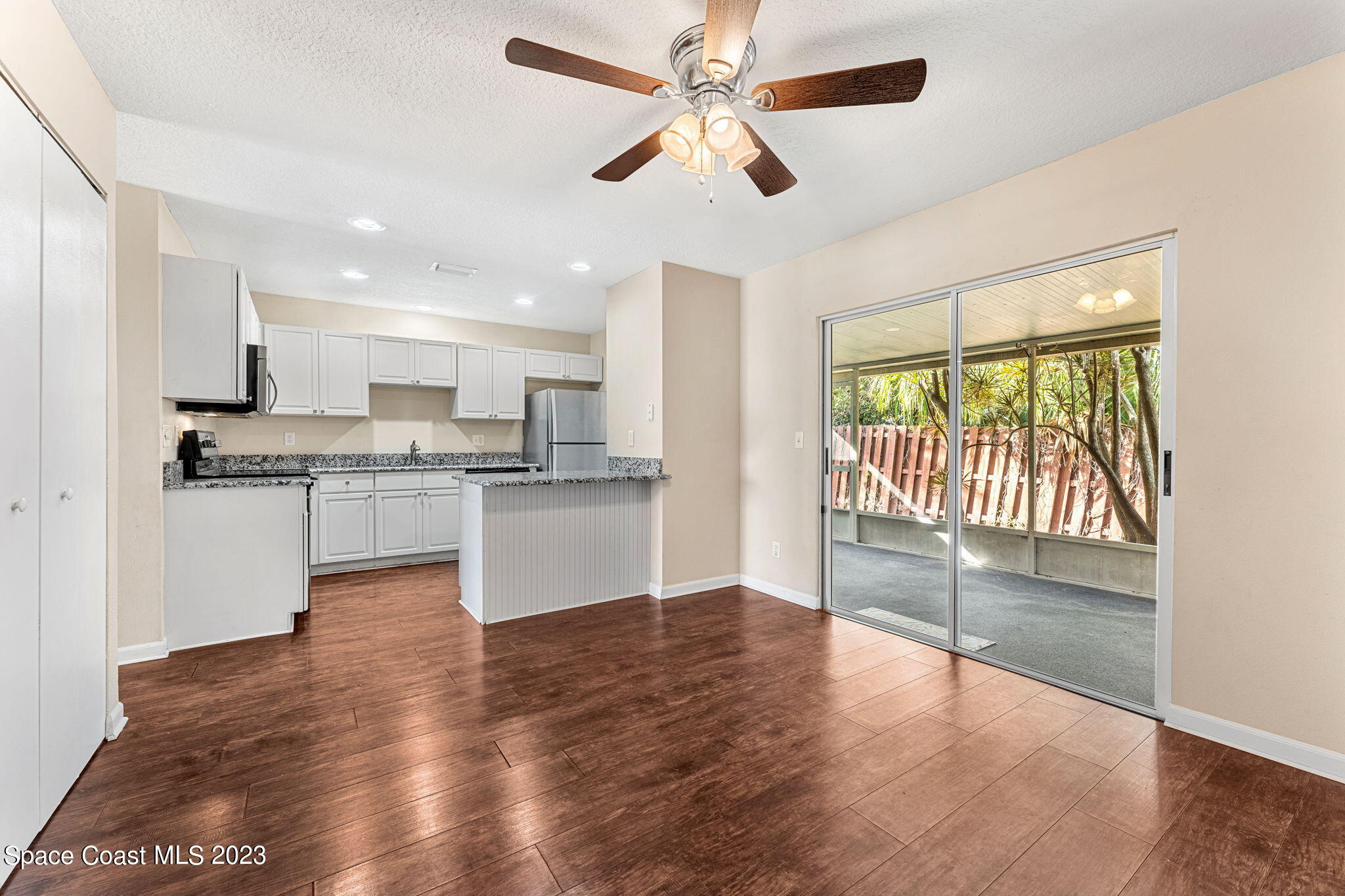 2717 Manor Drive Northeast Palm Bay, FL 32905 - Photo 4 of 21 a view of kitchen with granite countertop cabinets and wooden floor