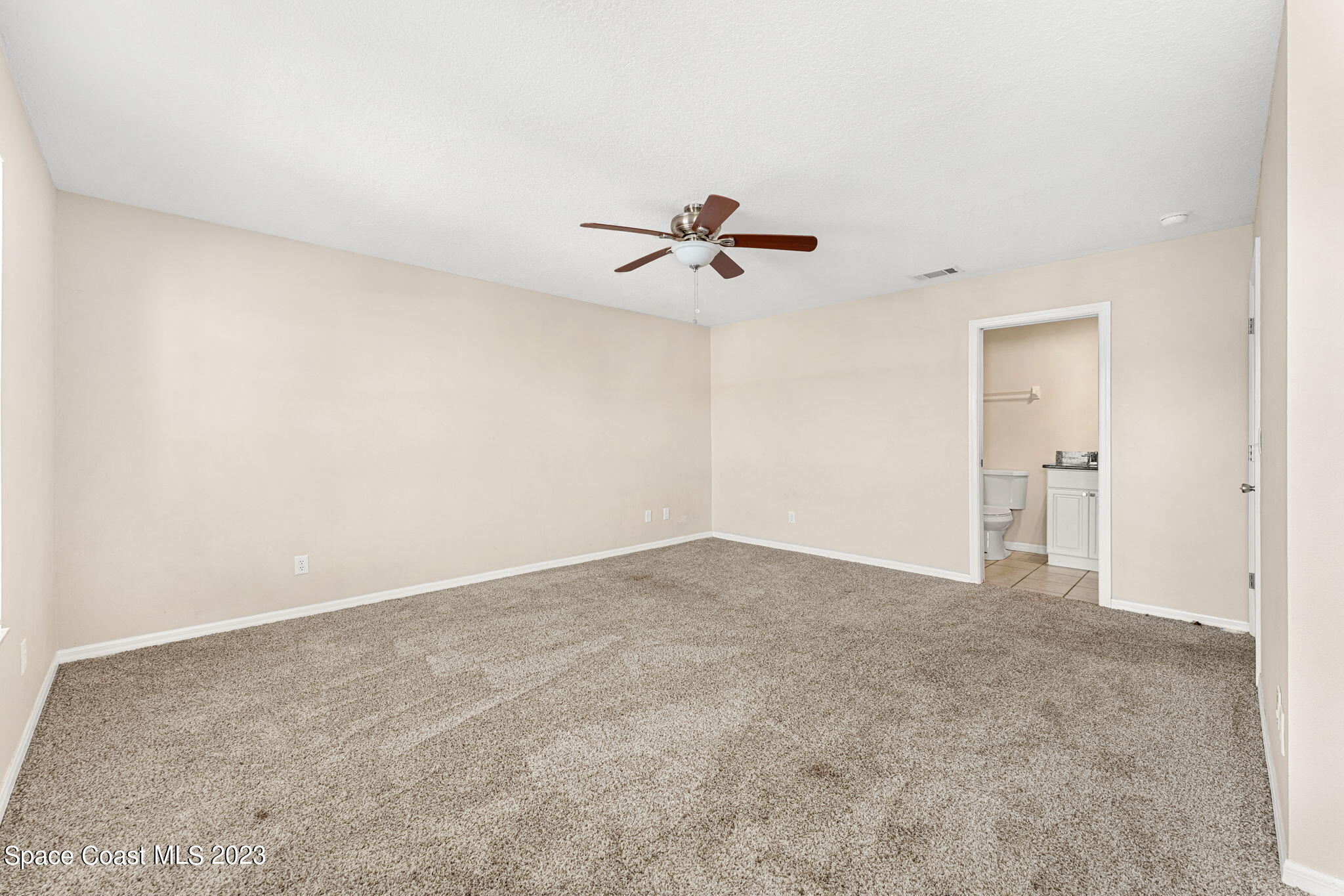 2717 Manor Drive Northeast Palm Bay, FL 32905 - Photo 8 of 21 a view of an empty room with a ceiling fan