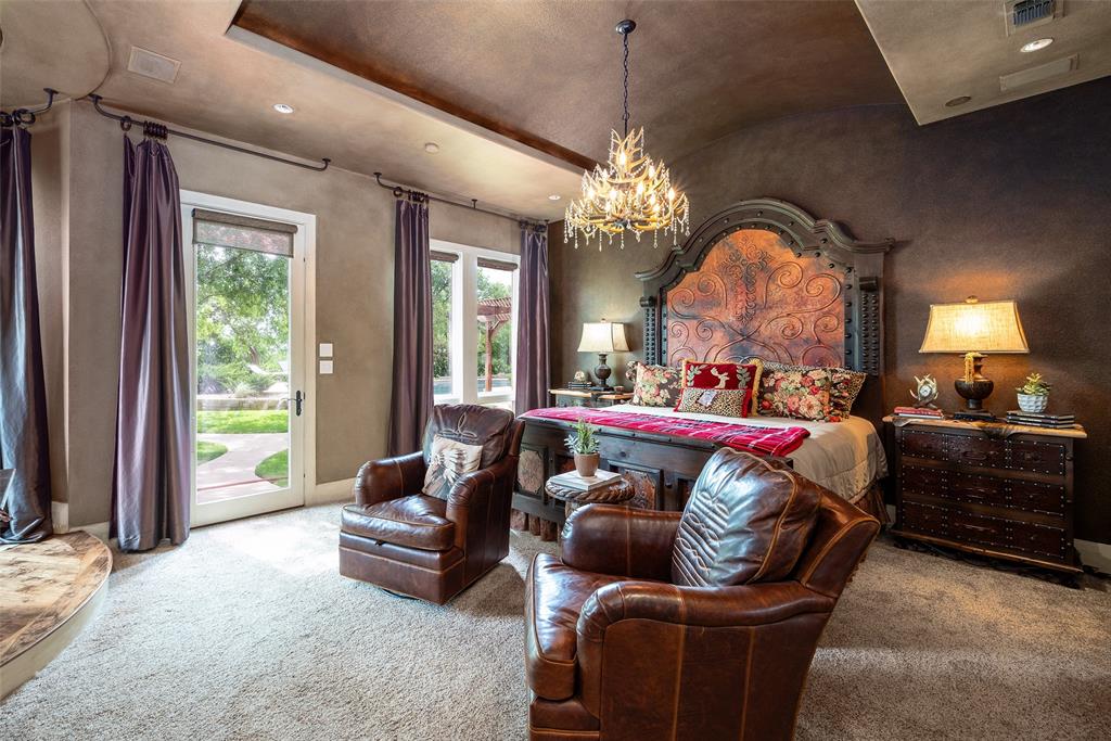 2312 Cactus Rio Lane Weatherford, TX 76087 - Photo 17 of 37 a bed room with a bed couch and a chandelier