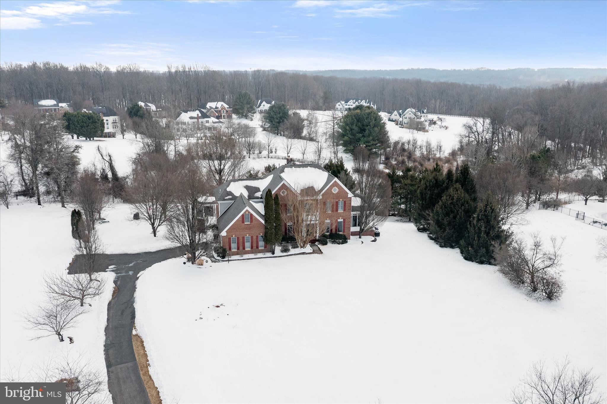 a view of a house with a yard covered in snow