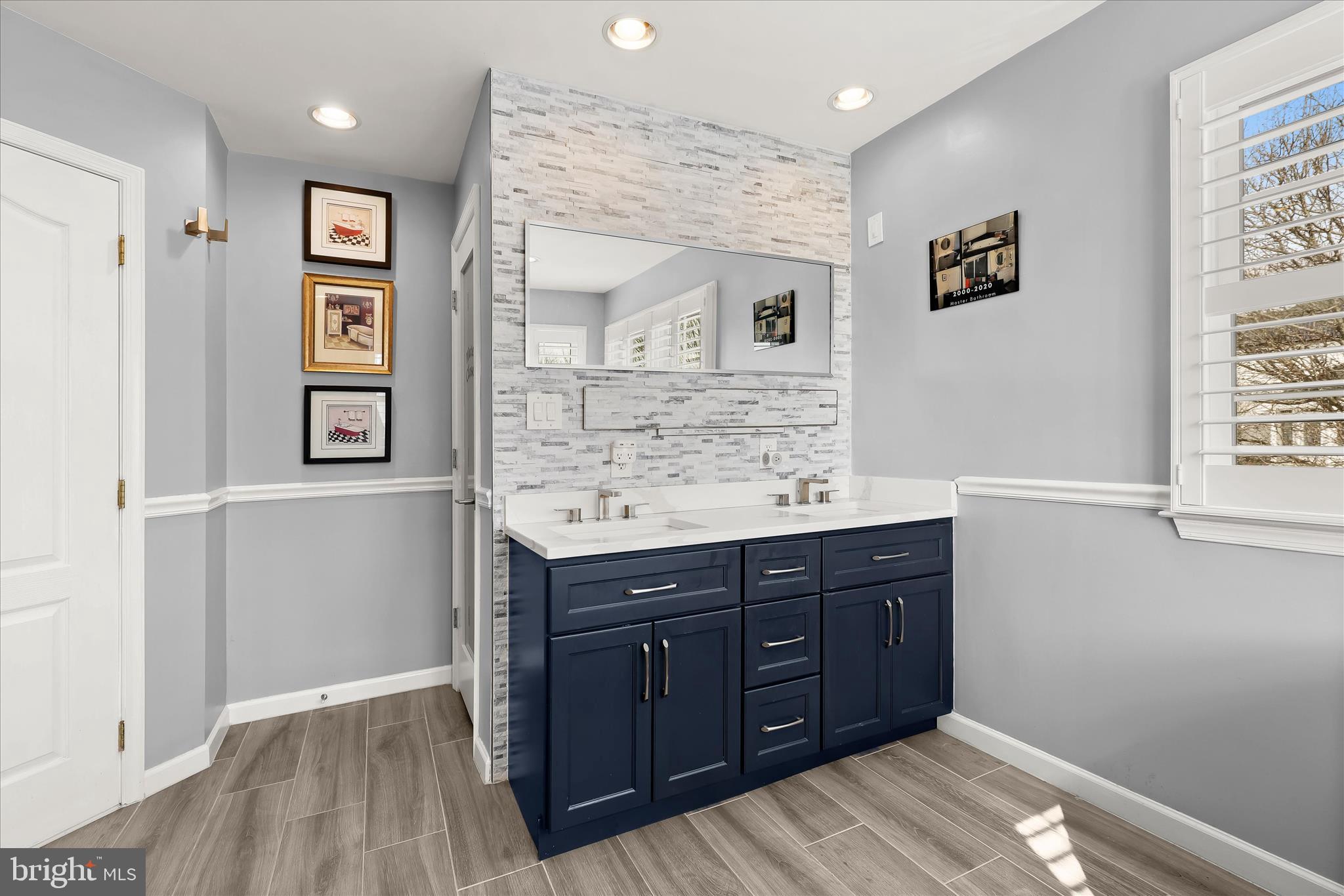 8061 Hunterbrooke Lane Fulton, MD 20759 - Photo 44 of 90 a spacious bathroom with a granite countertop sink and a mirror