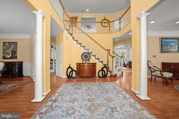 a dining room with furniture a chandelier and wooden floor