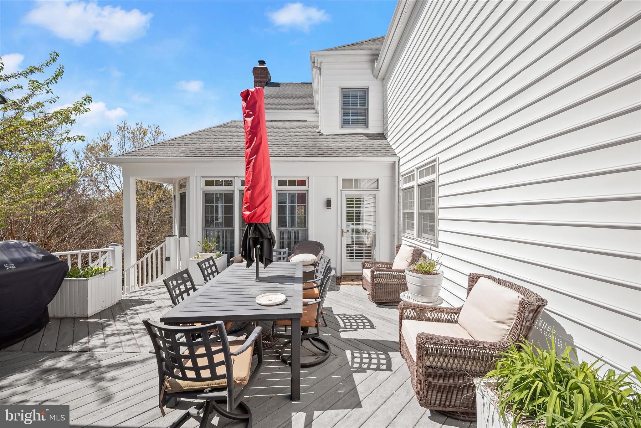 8061 Hunterbrooke Lane Fulton, MD 20759 - Photo 70 of 77 a view of a patio with a dining table and chairs with wooden floor and fence