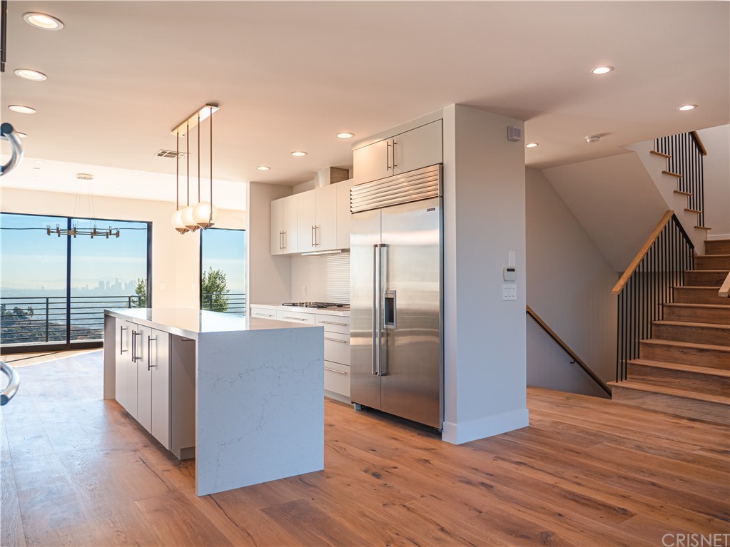 8184 Mannix Drive Los Angeles, CA 90046 - Photo 11 of 53 a kitchen with stainless steel appliances a refrigerator and a wooden floor