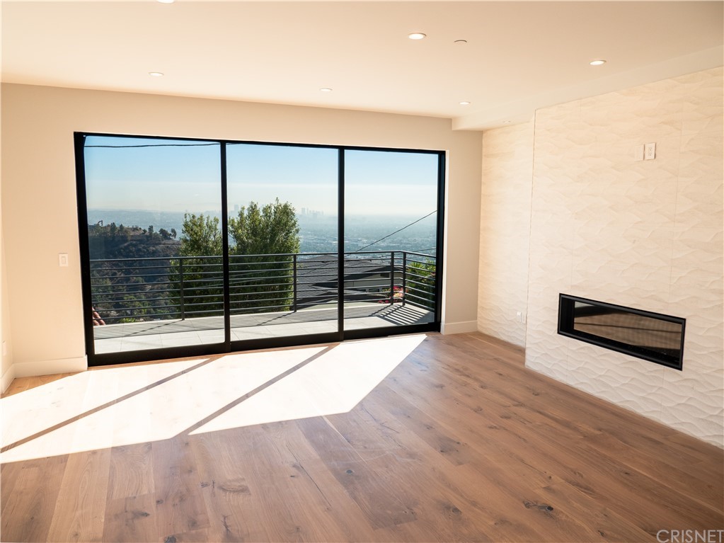 8184 Mannix Drive Los Angeles, CA 90046 - Photo 16 of 53 a view of an empty room with wooden floor and a window