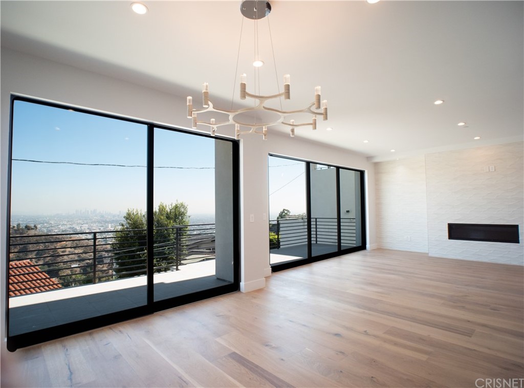 8184 Mannix Drive Los Angeles, CA 90046 - Photo 25 of 53 a view of an empty room with wooden floor and a window