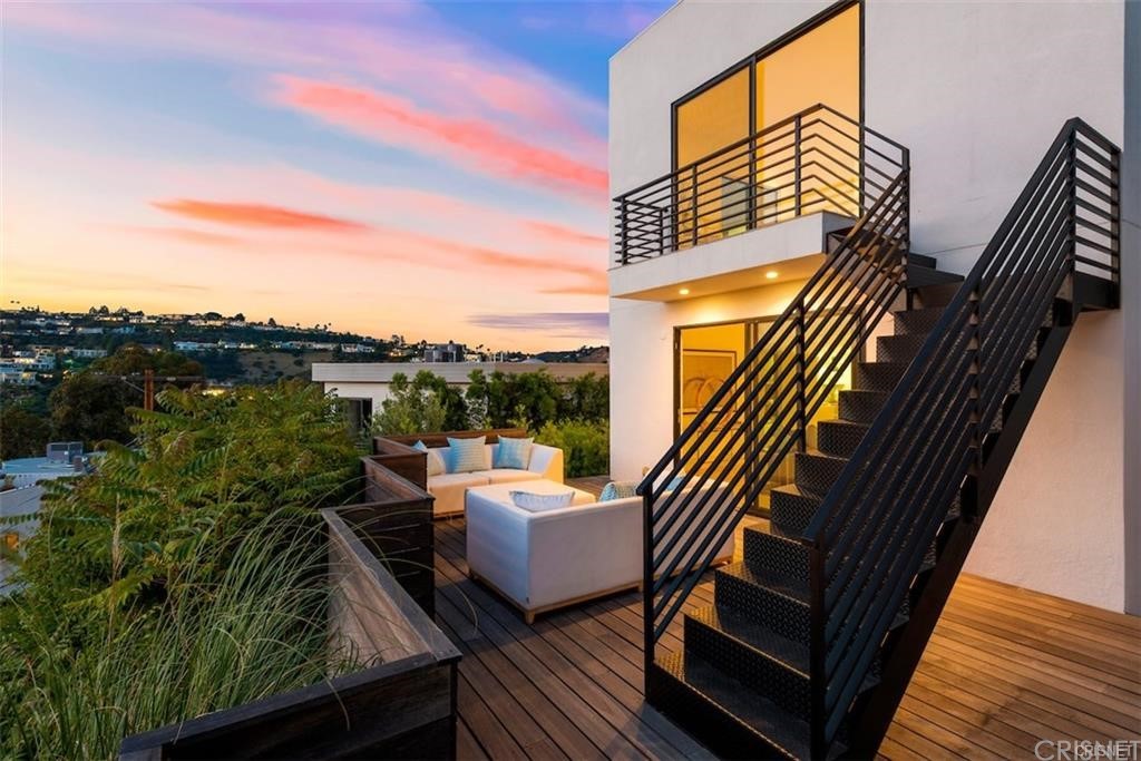8184 Mannix Drive Los Angeles, CA 90046 - Photo 7 of 53 a balcony with outdoor seating and wooden floor