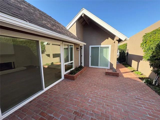 a view of a house with backyard porch and sitting area