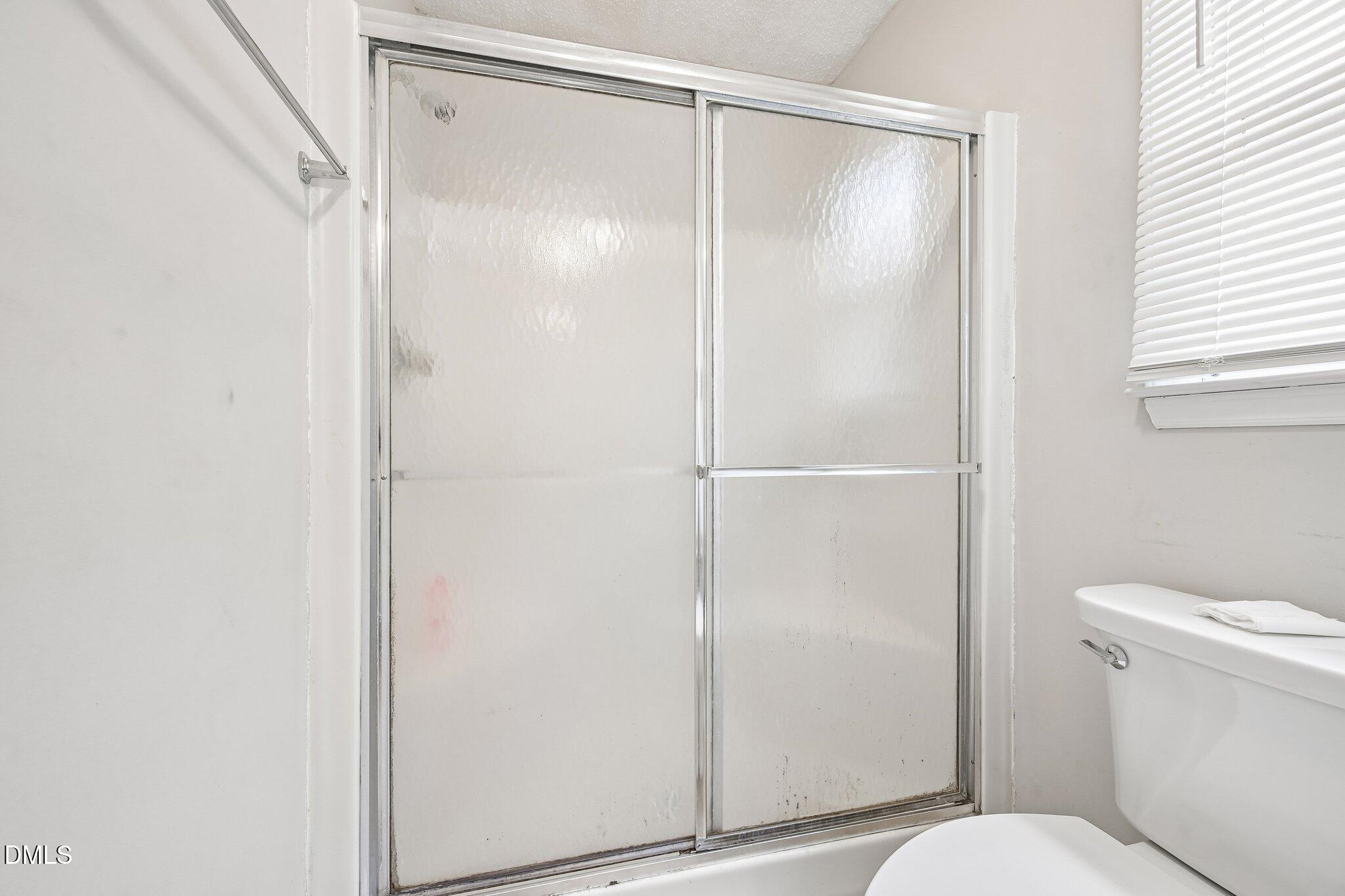 2800 West Jameson Road Raleigh, NC 27604 - Photo 15 of 24 a bathroom with a shower and a toilet