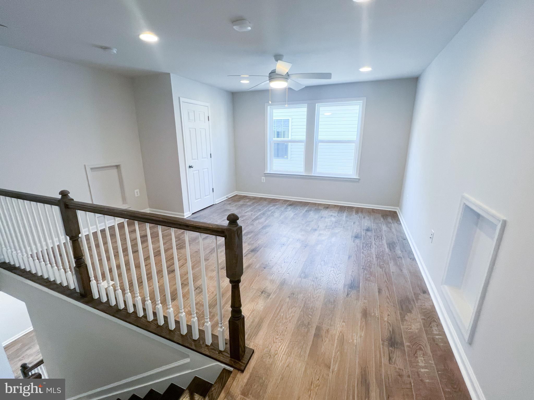 1015 Champlain Court Trappe, MD 21673 - Photo 12 of 38 a view of hallway with window and wooden floor