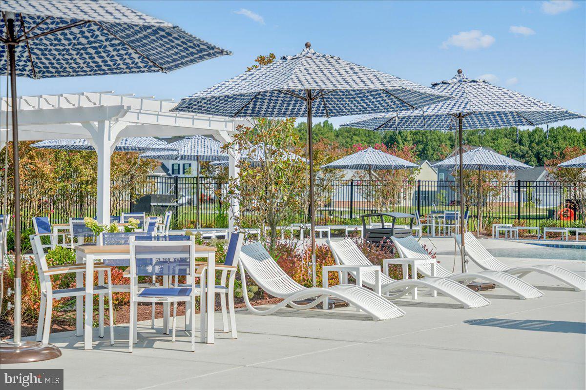 1015 Champlain Court Trappe, MD 21673 - Photo 25 of 38 a view of a patio with a table and chairs under an umbrella