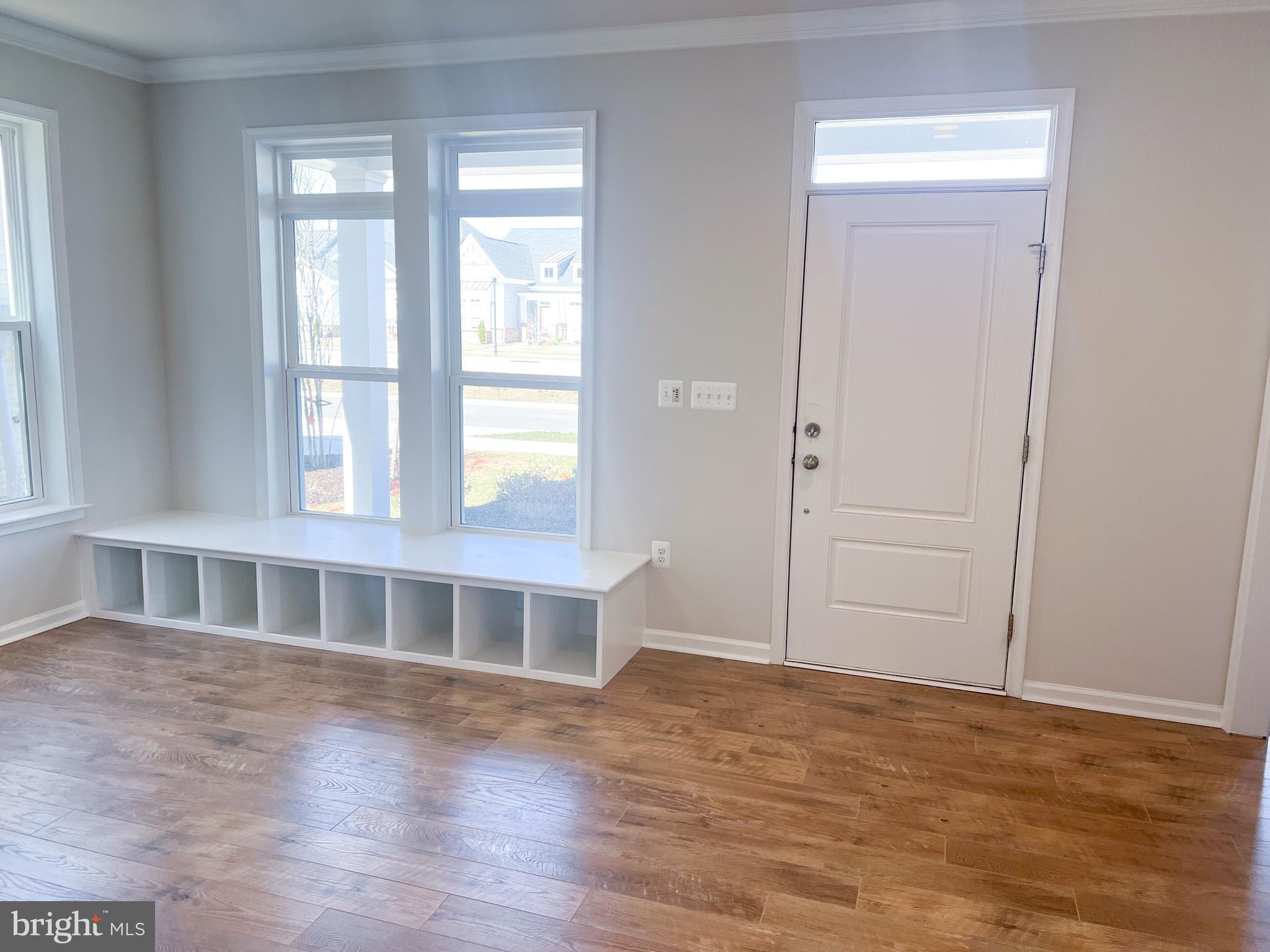 1015 Champlain Court Trappe, MD 21673 - Photo 3 of 38 a view of an empty room with wooden floor and a window