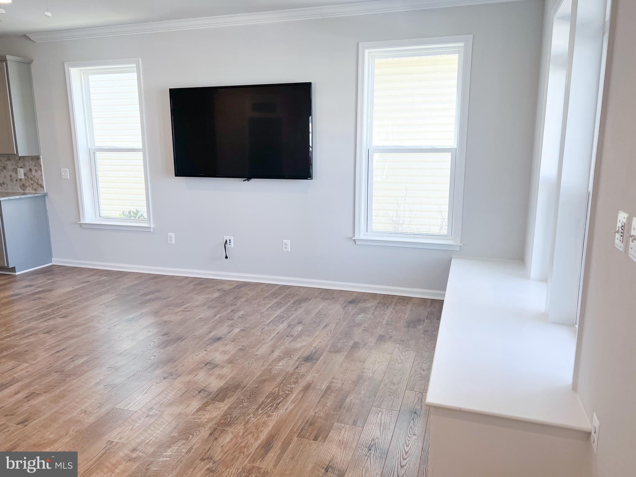 1015 Champlain Court Trappe, MD 21673 - Photo 4 of 38 a view of an empty room with wooden floor and windows