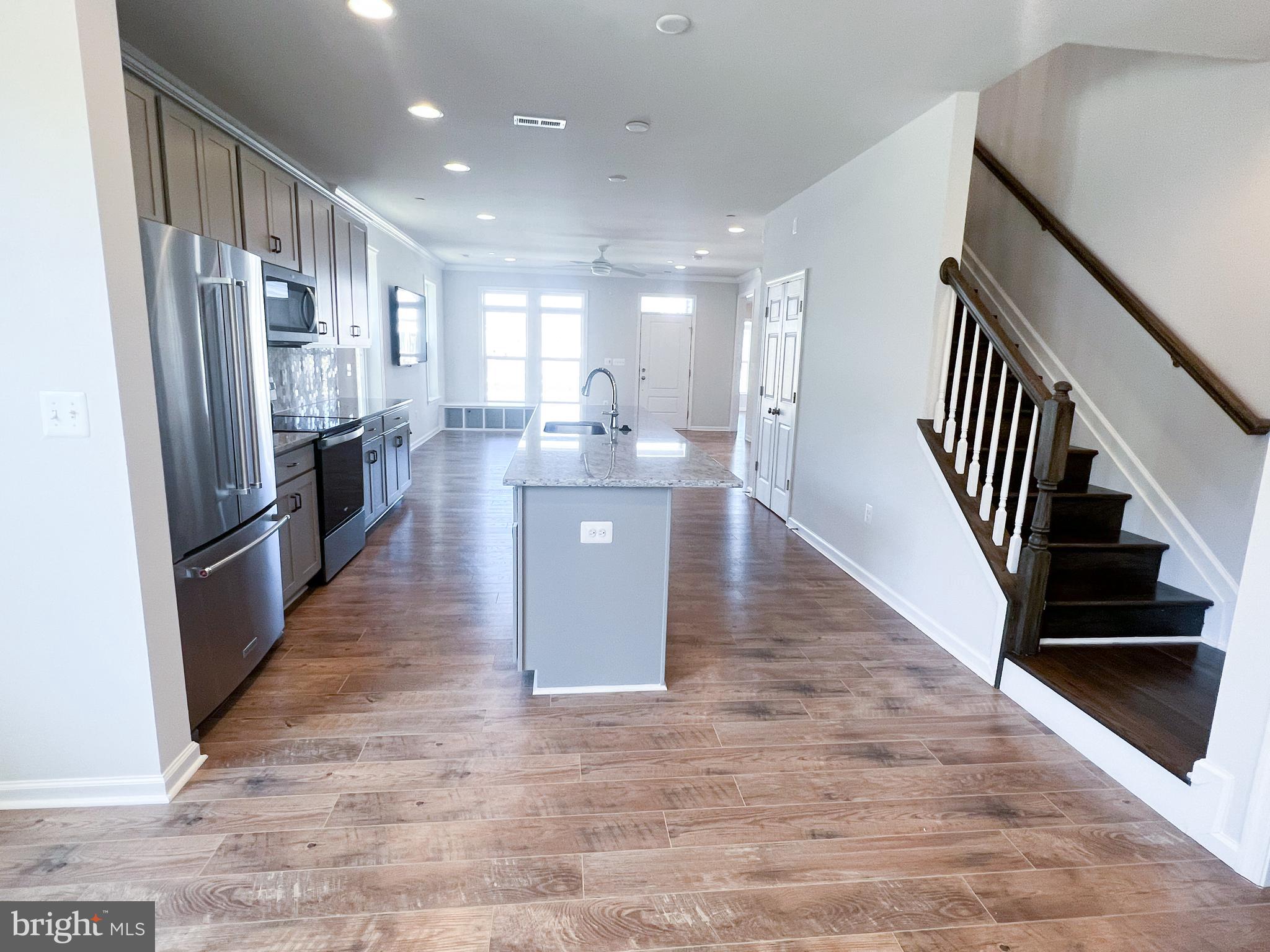 1015 Champlain Court Trappe, MD 21673 - Photo 6 of 38 a view of a kitchen with refrigerator and wooden floor