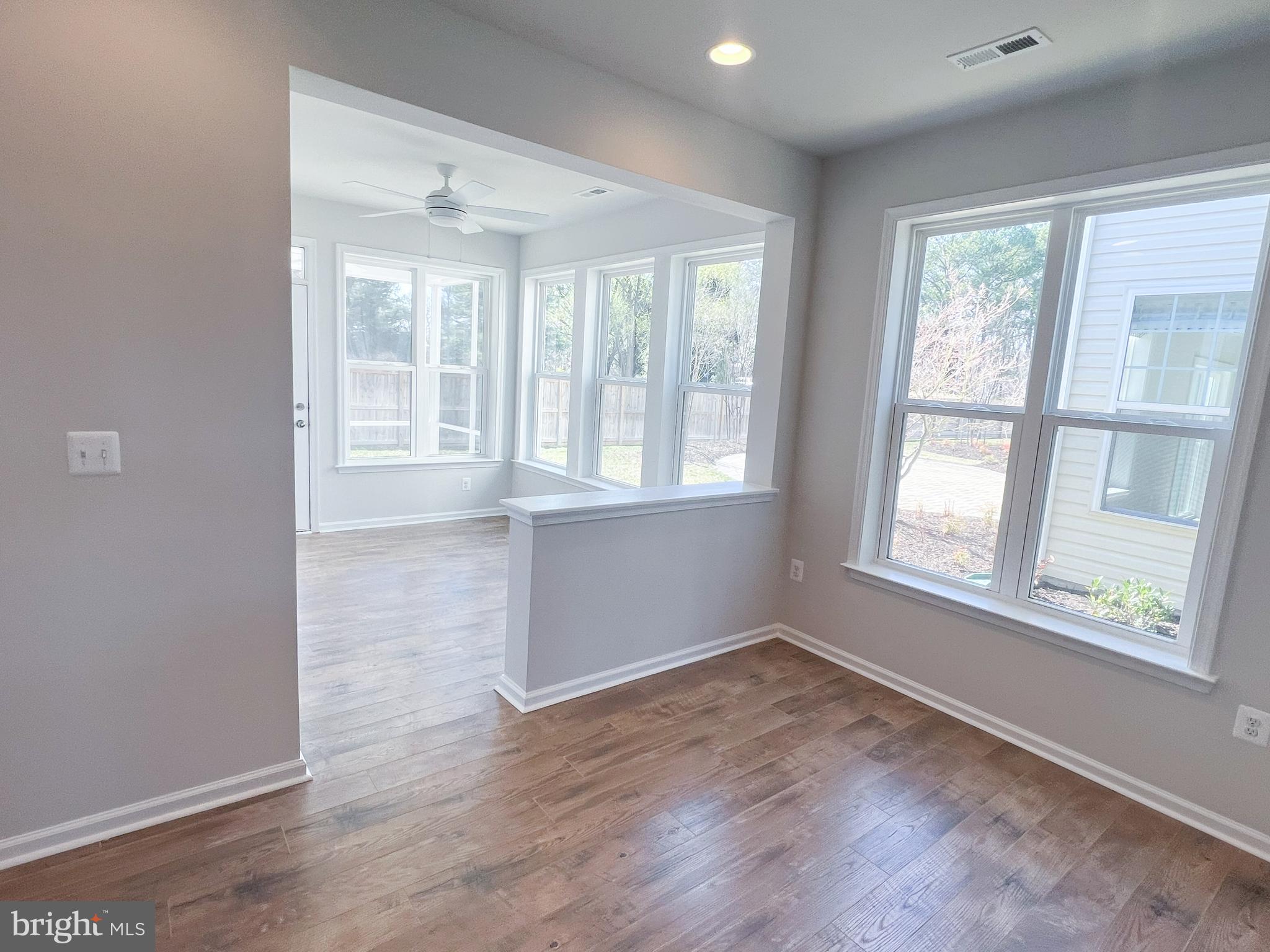 1015 Champlain Court Trappe, MD 21673 - Photo 7 of 38 an empty room with wooden floor and windows