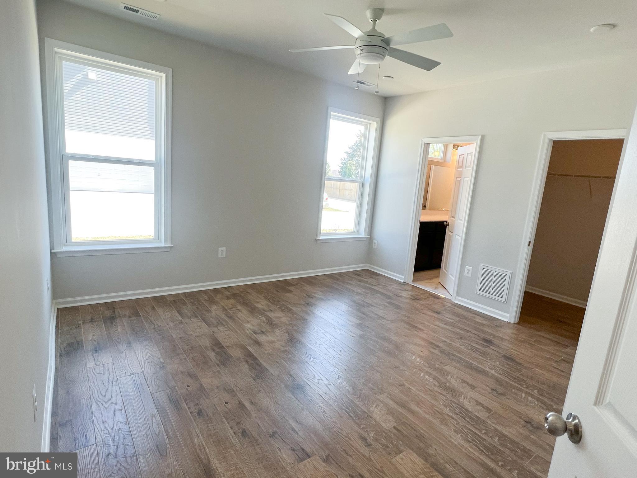 1015 Champlain Court Trappe, MD 21673 - Photo 9 of 38 a view of an empty room with wooden floor and a window